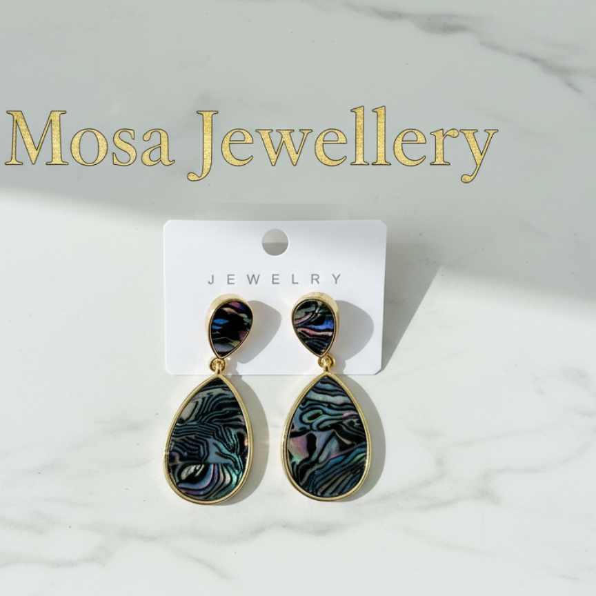 Teardrop-shaped earrings on a Mosa Jewellery card against a marble background