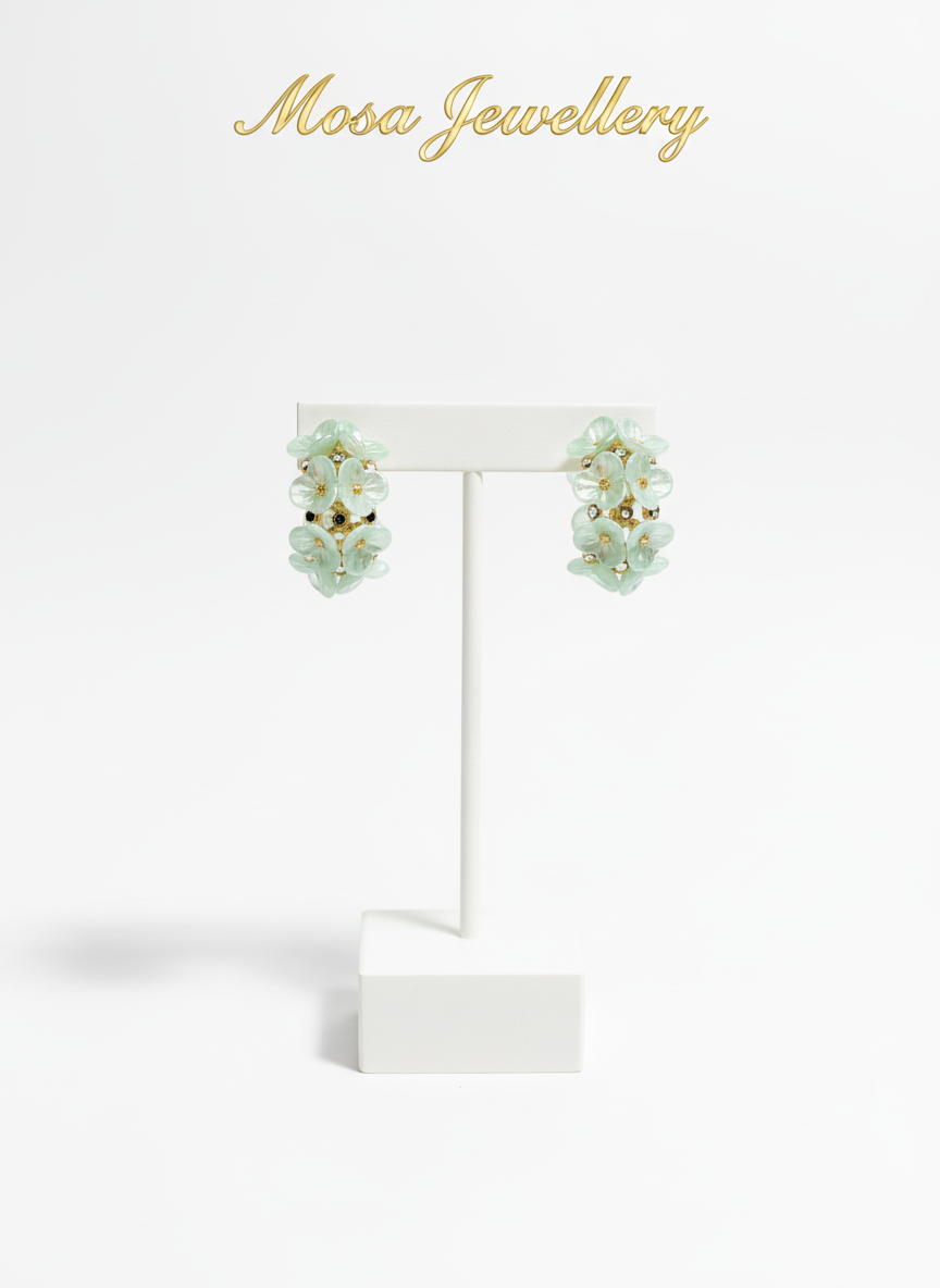 Pair of green floral earrings on a black background with 'Mosa Jewellery' text.