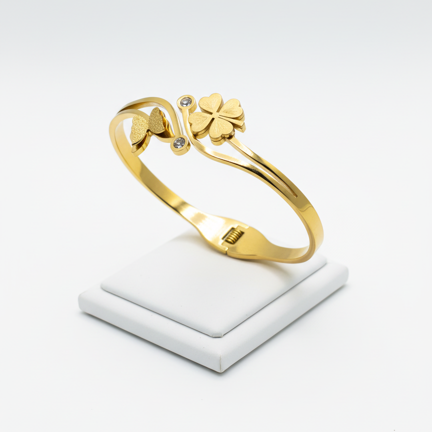 Gold bracelet with floral design on a white platform, branded as Mosa Jewellery.