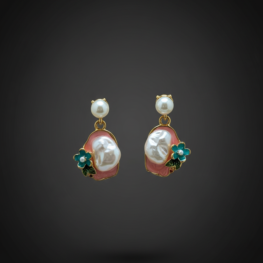 Pair of pearl earrings with floral accents on a dark background, branded 'Mosa Jewellery'.