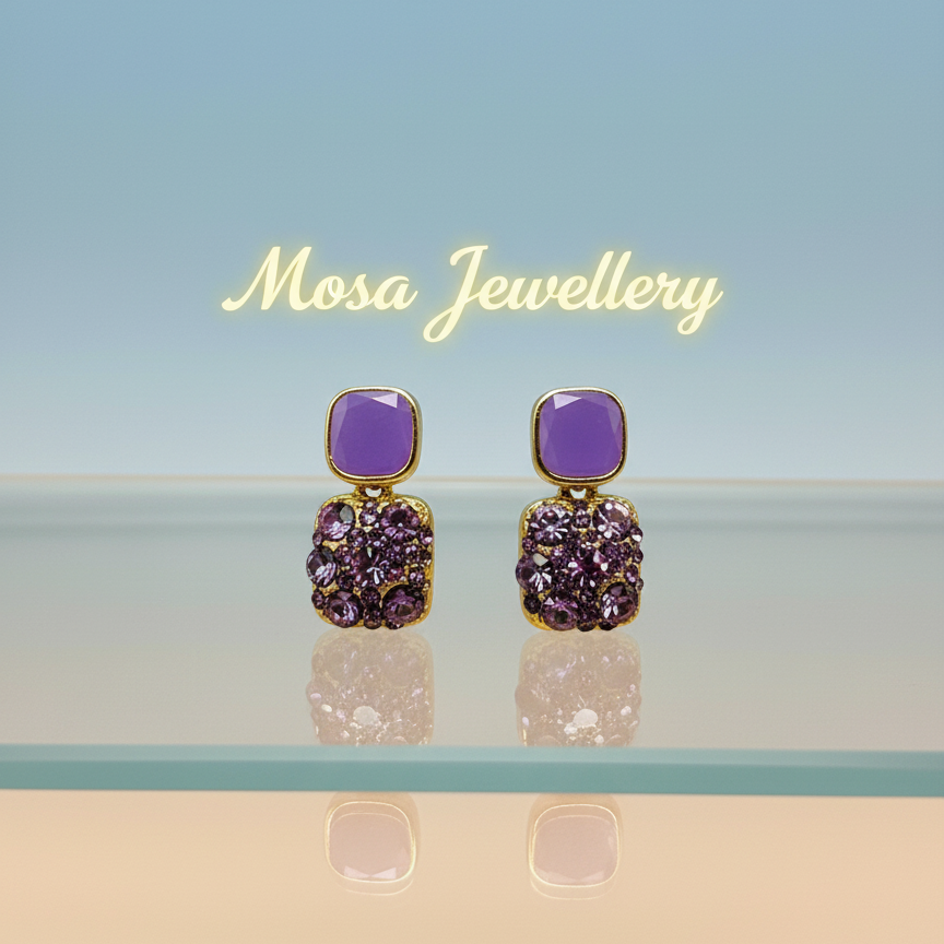 Purple and gold earrings on a reflective surface with 'Mosa Jewellery' branding.