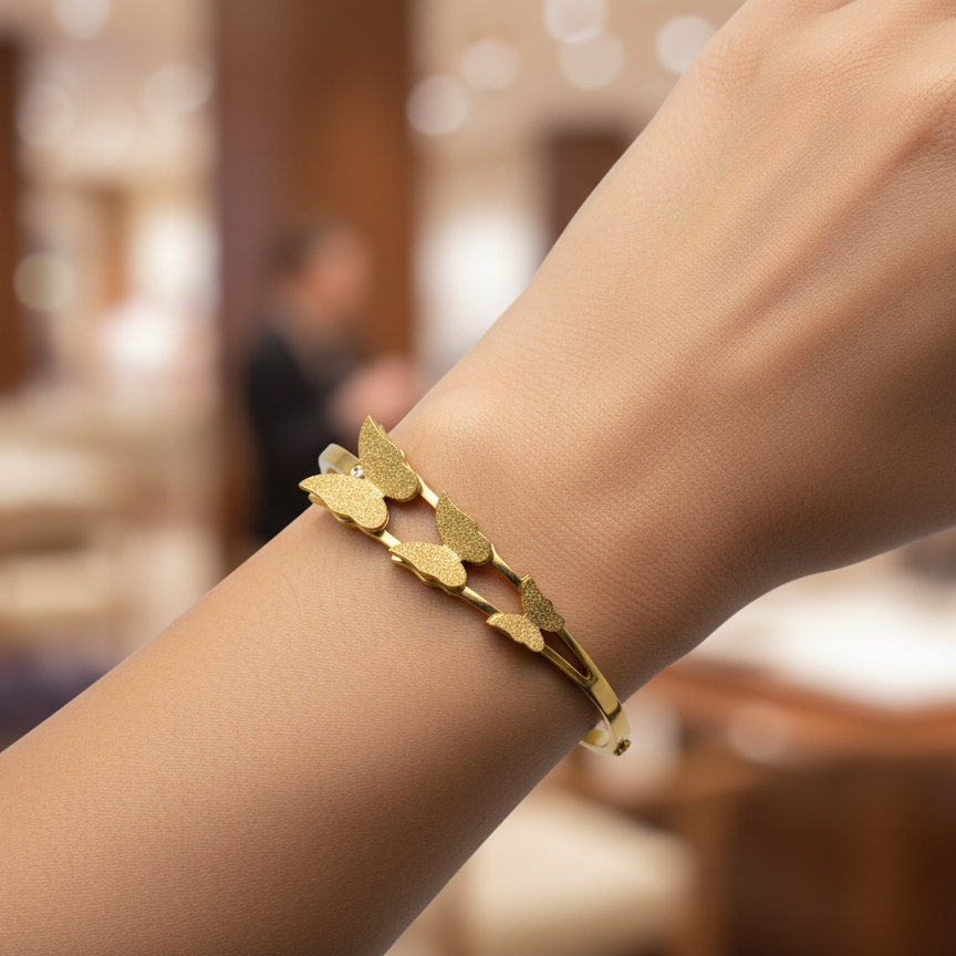 Gold bracelet on a wrist with a blurred indoor background