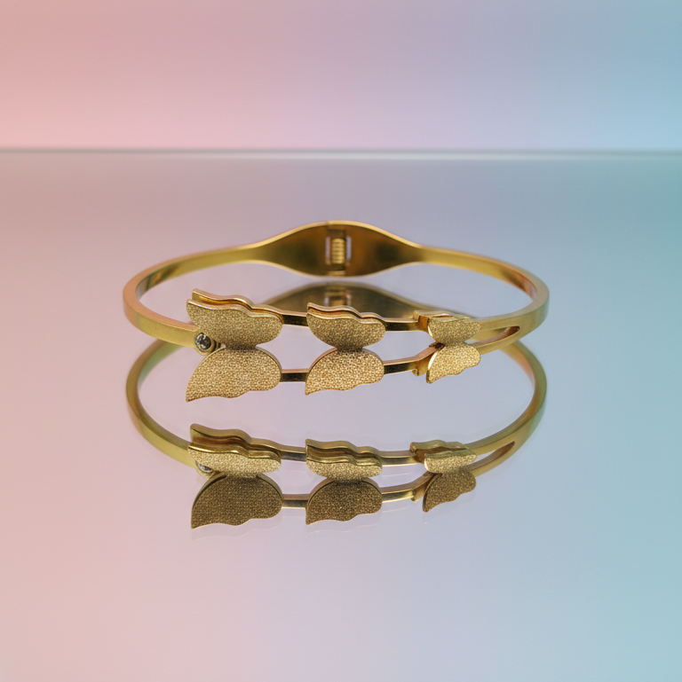 Gold bracelet with leaf designs on a gradient background
