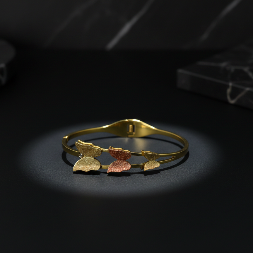 Gold bracelet with leaf-shaped charms on a dark background