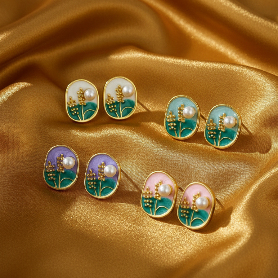 Set of earrings with floral designs on a gold satin background